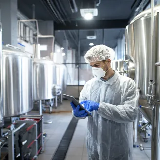 Man in protective gear in food processing environment