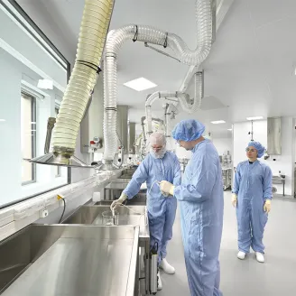 Three persons working in a medtech facility